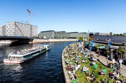 Berlin, June 2015.People taking sun along the Spree river. Berlin  is the capital of Germany, and one of the 16 states of Germany. With a population of 3.5 million people, Berlin is Germany's largest city. It is the second most populous city  and the seventh most populous urban area in the European Union
