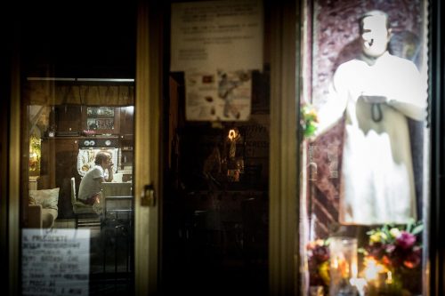 Naples, Italy. a man is watching tv in his house.