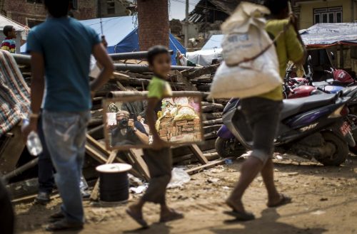 Nepal, 18 may 2015.People are cleaning up the rest of destroied houses in Dharmasthali.